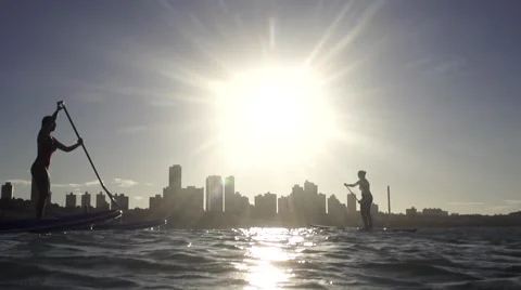 Couple in stand up paddle at Natal sunset in slowmotion Stock Footage 68086641