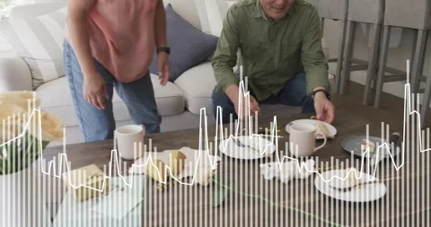 Couple standing after talk, clearing coffee table for food, waveform overlaying Video stock 322203111