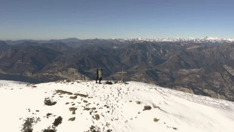 Couple standing alone looking out over view on top of mountain Video stock 102495225