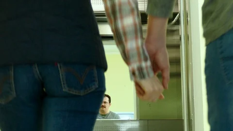 Couple standing and kissing in the elevator Stock Footage 86015229
