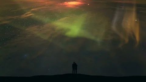 The couple standing on a background of starry sky with a northern light Stock-Footage 97364586