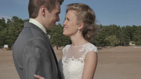 Couple standing on beach facing each other, close-up, camera movement Stock Footage 64817860