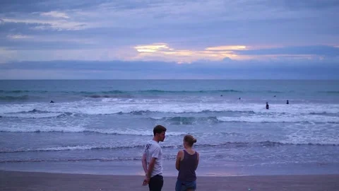 A couple standing on a beach having a romantic conversation Stock Footage 237265621