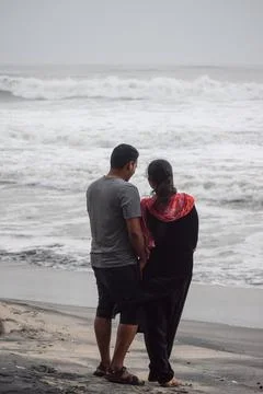 Couple standing at beach Stock Photos