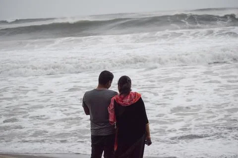 Couple standing at beach Stock Photos