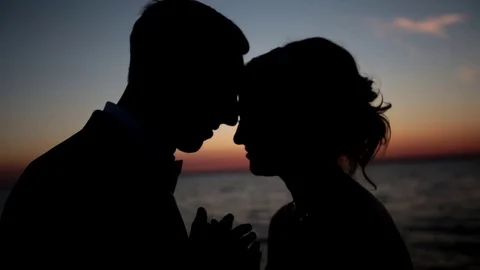 Couple standing on the beach at sunset. Close-up Stock Footage 70586351
