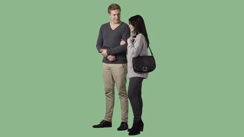 The couple is standing, discussing, looking at something. Green screen clip Stock Footage 71308233
