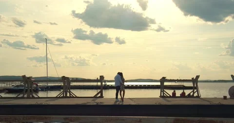 A couple is standing on the dock and hugging Video stock 156553431
