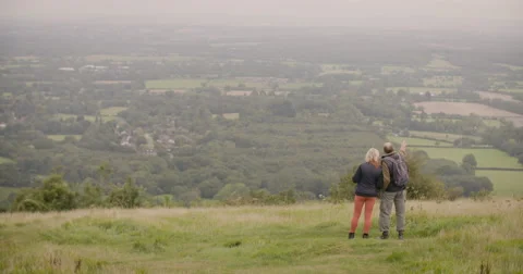Couple standing in field and looking at distance Stock Footage 59899716