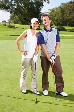 Couple standing on the golf course. Full length of couple standing on the golf Fotos Stock