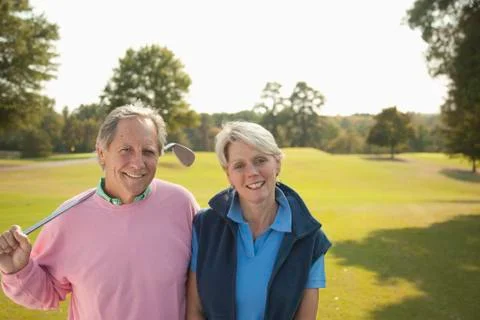 Couple standing on golf course Fotos Stock