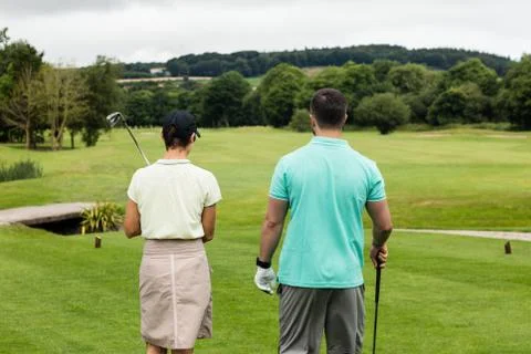 Couple standing on a golf course Fotos Stock