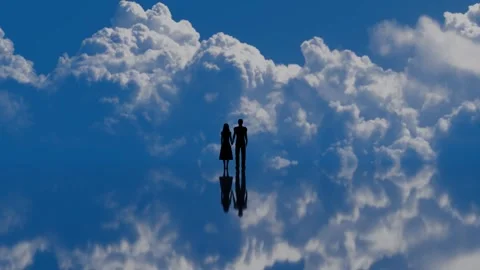 A couple standing on a mirror lake, reflecting time lapse clouds movement Stock Footage 246782875