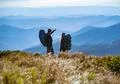 The couple standing on the mountain with a beautiful view Photo