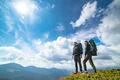 The couple standing on the mountain with a picturesque cloudscape Photo