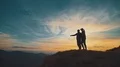 The couple standing on the mountain on the sunset background 4k or 4k+ Resolution
