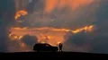 The couple standing near a car against the cloud stream. time lapse 4k or 4k+ Resolution