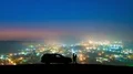The couple standing near a car against the night city. time lapse 4k or 4k+ Resolution