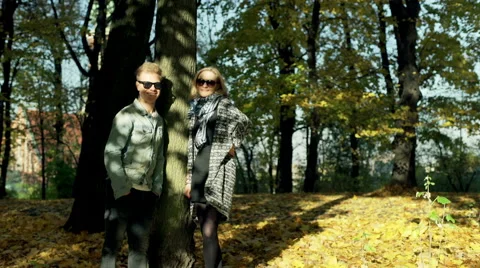 Couple standing next to the tree and smiling to the camera Stock-Footage 57800853