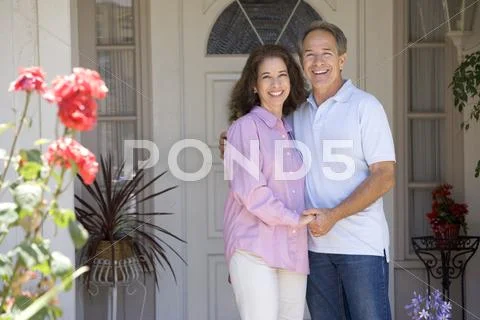Couple Standing Outside Their House Stock-Fotos