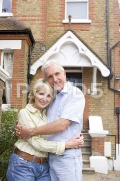 Couple Standing Outside Their House Stock Photos