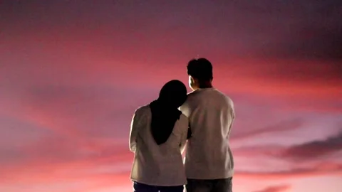 Couple standing in the park at sunset Stock Footage 172108301