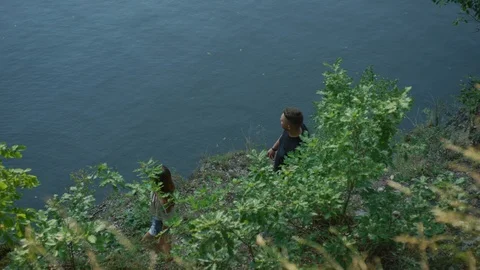 Couple standing by a river Stock Footage 99968231