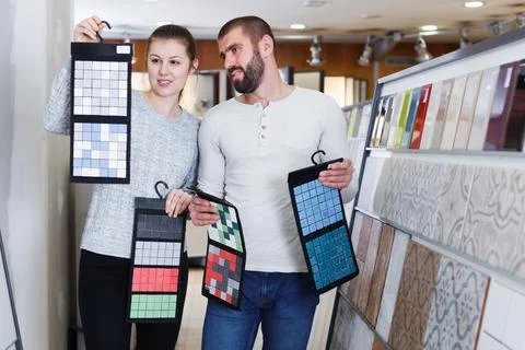 Couple standing with sample of ceramic tile Stock Photos