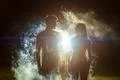 The couple standing in the smoke on a bright light background Photo