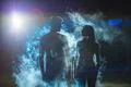 The couple standing in the smoke on a dark street Photo