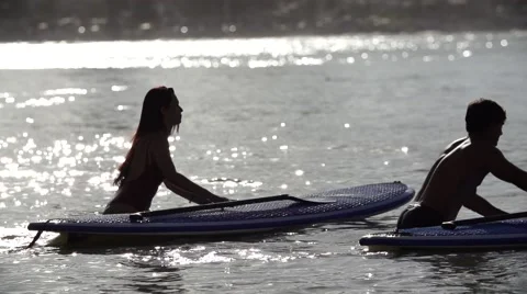 Couple standing at a stand up paddle in slowmotion Stock Footage 68086288