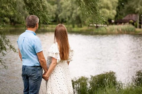 Couple standing with their backs to the camera, woman pregnant Stock Photos