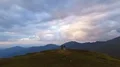 The couple standing on the top of a mountain on a sunset background 4k or 4k+ Resolution