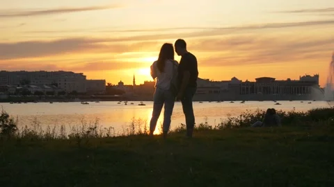 Couple Stands Against the Background of the Sunset of the City Stock Footage 134284769