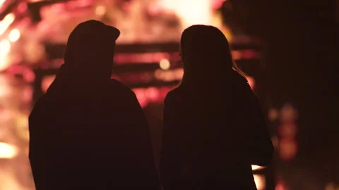 Couple stands in front of a huge fire Stock Footage 267013291