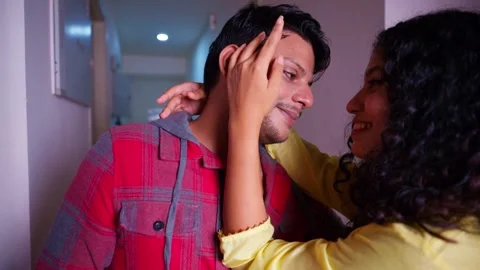 Couple stands inside gently touching and teasing each other Stock-Footage 297243809