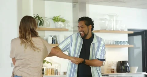 Couple starting playful spin after man entering smiling reaching hands, dancing Stock Footage 343839428