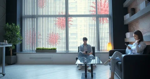 Couple staying at home, working, using phones, siting on sofa at home, using Stock Footage 127346602