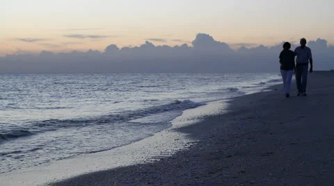 Couple Stroll Beach At Dusk Video stock 1446241