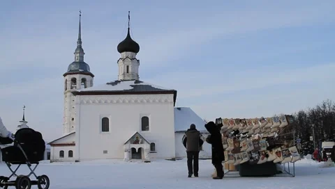 Couple with a stroller walking in front of the traditional church Stock Footage 3476596