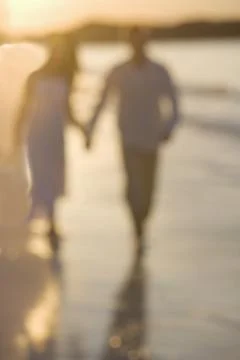 Couple strolling on a beach Fotos Stock