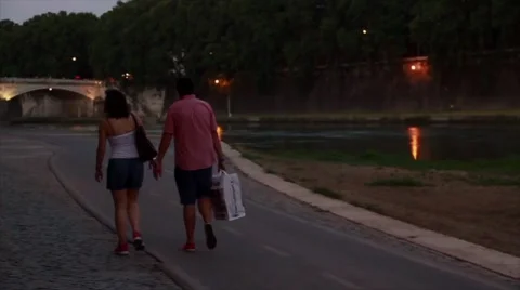 Couple Strolling by River in Rome Stock Footage 52932798