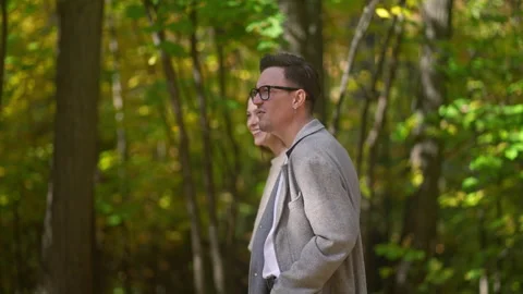 A Couple Strolling Together in a Tranquil and Serene Pathway Through a Beautiful Stock Footage 288435562