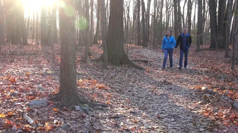 A couple strolls in the forest Stock Footage 70261293