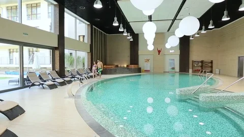Couple strolls by the pool Stock Footage 73603564