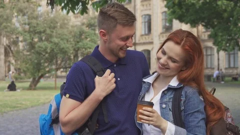 Couple of students flirts on campus Stock Footage 79783143