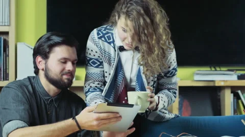 Couple of students using a tablet slow motion Stock Footage 59186162