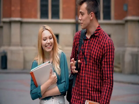 Couple of students walking and talking outdoor Stock Footage