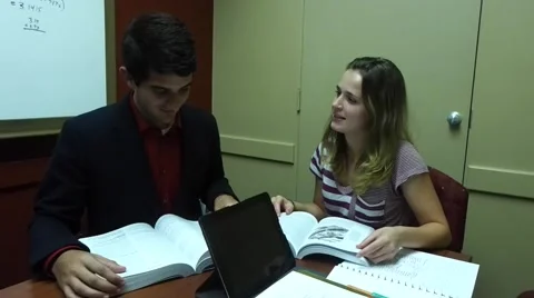 Couple studying together in a library Stock Footage 52046653