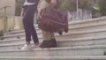 Couple with suitcases going down stairs outdoors, tourists on way to hotel HD Footage